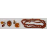 A collection of Silver mounted Amber jewellry, amber bead necklace etc