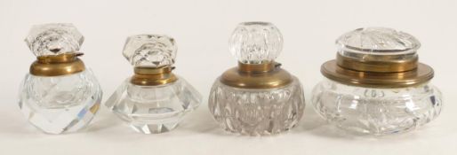 Four heavy glass crystal inkwells with brass fittings, tallest 10cm. (4)