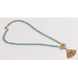 Green beads choker with heavy gold plated pendant and pendant fittings with enamel decoration.