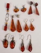 A collection of Amber Earring some with white metal mounts(7 pairs 1 (a/f))
