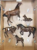 A group of Royal Doulton Horse Figures to include swish tail horse, stocky jogging mare, 3 foals all