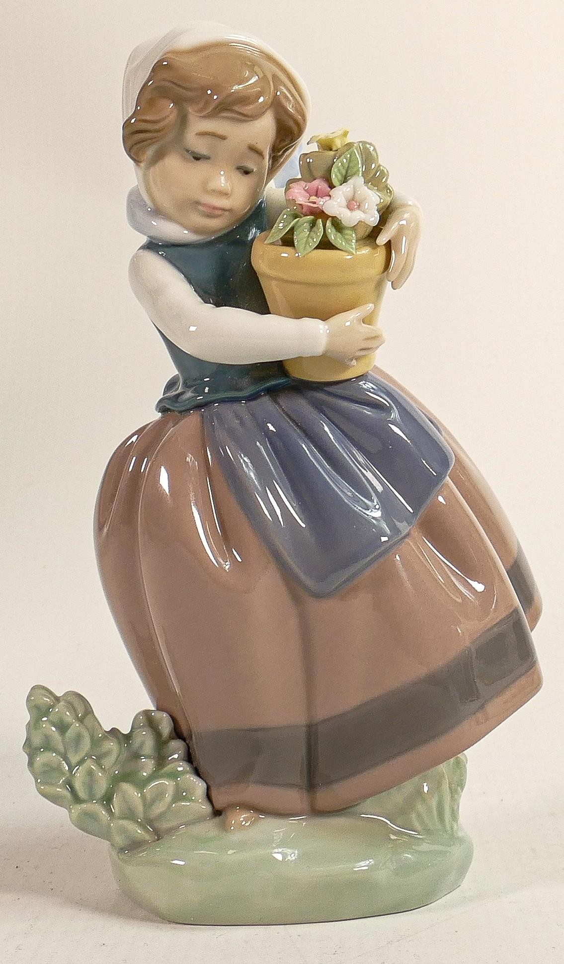 Lladro figure of child holding a flower pot 5223, height 17cm.