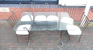 Italian glass top and wrought iron table, with six chairs & cushions. Table height 80 cm Chair