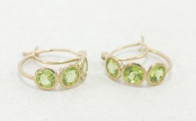Pair 9ct gold earrings, each set with three green stones 2.1g. (2)