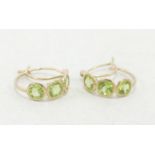 Pair 9ct gold earrings, each set with three green stones 2.1g. (2)