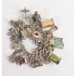 Silver vintage charm bracelet with appx. 28 charms, including £1 & 10/- note charms, weighing 108.2g