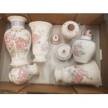 A collection of Wade floral patterned items including vases, trinket pots, lidded vases etc (1