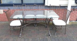 Italian glass top and wrought iron table, with six chairs & cushions. Table height 80 cm Chair