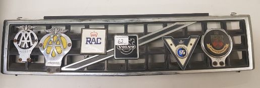 Vintage Volvo front grille with AA and RAC and similar badges attached.