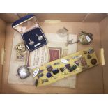 A mixed collection of items to include a sterling silver vesta case, RAF cap badge, group of lapel