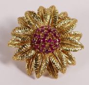 18ct gold flower & leaf brooch set with rubies to the centre,makers mark "dem" for De Maurier Jewels