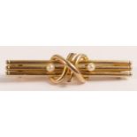 Yellow metal bar brooch set with seed pearls, marked 15ct and tested as such, 42mm wide, 3.4g.