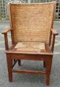 Oak framed Orkney chair with woven and stitched curved rush back, open armrests and woven seagrass