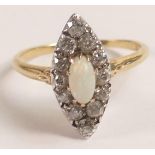 Diamond & opal set yellow metal ring set with oval opal center stone surrounded by 12 old cut