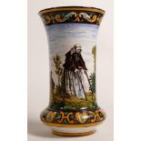 Early 20th century continental Faience vase decorated with old woman and man in church yard, h.21cm.