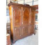 Edwardian mahogany triple three door wardrobe with carved relief to doors, height 215cm, length