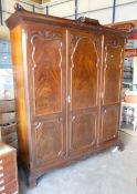 Edwardian mahogany triple three door wardrobe with carved relief to doors, height 215cm, length