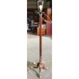 Victorian mahogany carved standard lamp with tripod base.
