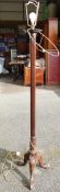 Victorian mahogany carved standard lamp with tripod base.