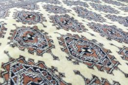 Large hand tied cream Bokhara patterned rug, 190cm x 129cm