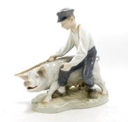 Royal Copenhagen model of farm boy with pig 848, h.18.5cm.