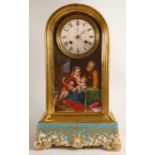 Early 20th century gilded pottery clock case, the front hand painted with father, mother & babies