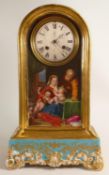 Early 20th century gilded pottery clock case, the front hand painted with father, mother & babies