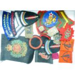 A collection of various military uniform badges, badges and patches, including Royal Engineers,