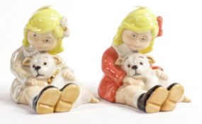 Wade Sarah & puppy figures in different colourways, one signed JW & the other signed KM. Height 9cm.