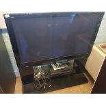 Panasonic Viera plasma HD TV fixed to glass stand, Model TH-50PZ81B, together with Technics DVD