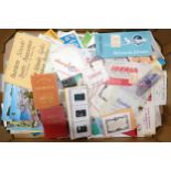A collection of vintage travel memorabilia to include plane tickets, luggage labels, postcards and