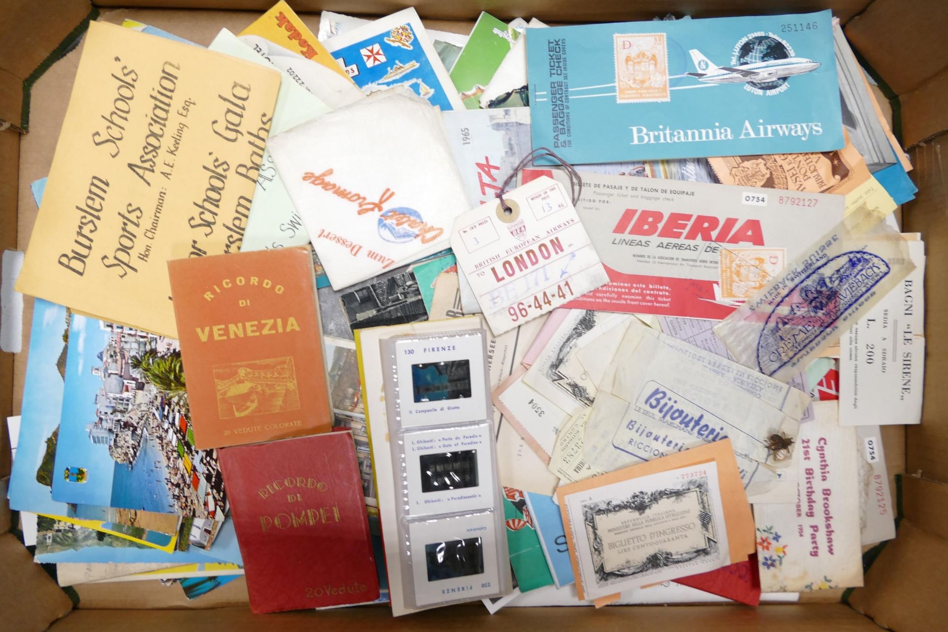 A collection of vintage travel memorabilia to include plane tickets, luggage labels, postcards and