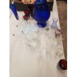 A large collection of glass ware to include vases, drinking glasses, very large blue glass