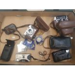 A collection of vintage cameras and commemorative coins (1 tray).