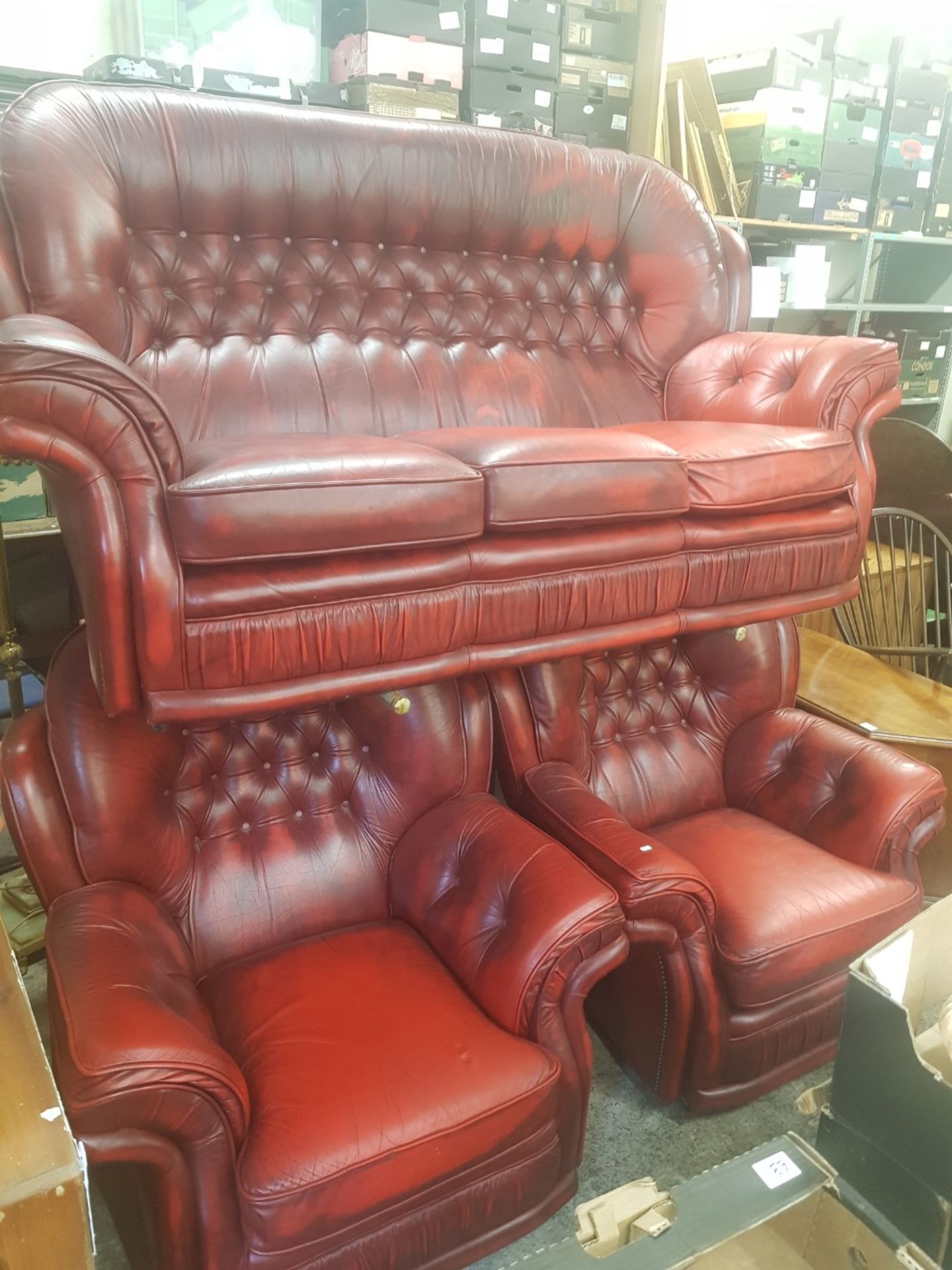 Oxblood leather Chesterfield high back 3 seater sofa and 2 matching armchairs.