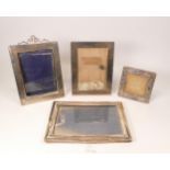 4 x silver hallmarked photo frames, the largest measuring 21.5cm x 15cm, the smallest with areas