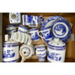 A collection of Wade Ceramic Ringtons advertising items to include storage jars, teapot, mugs