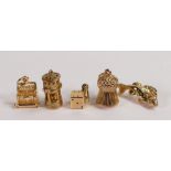 Five 9ct gold charms, typewriter,miners lamp, fish, thistle and dice,10.6g. (5)