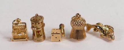 Five 9ct gold charms, typewriter,miners lamp, fish, thistle and dice,10.6g. (5)