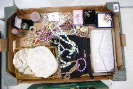 A good collection of costume jewellery including bead, brooches, evening bags, earrings etc