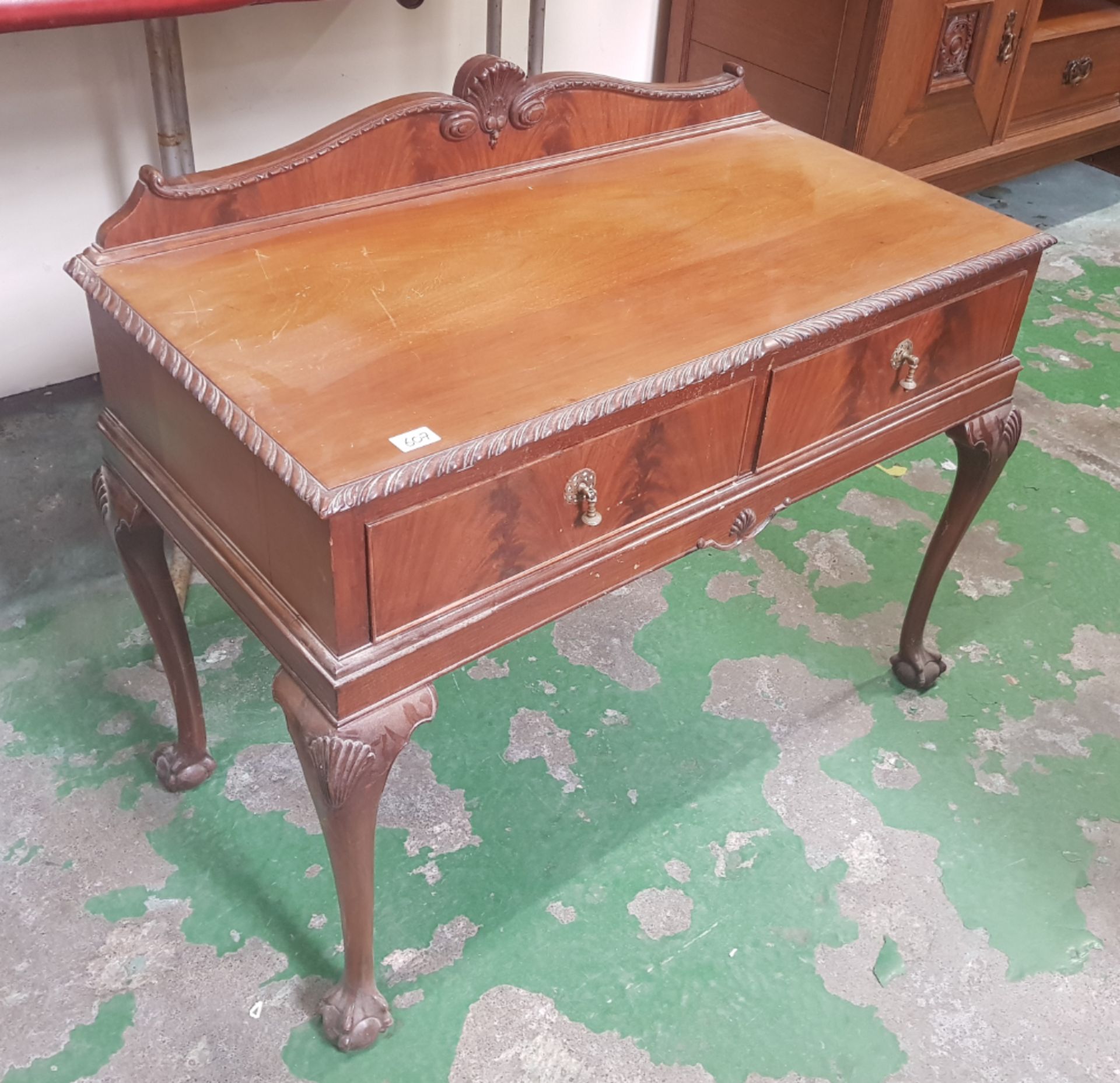 Mahogany side table / desk with 2 drawers standing on ball and claw feet 107cm W