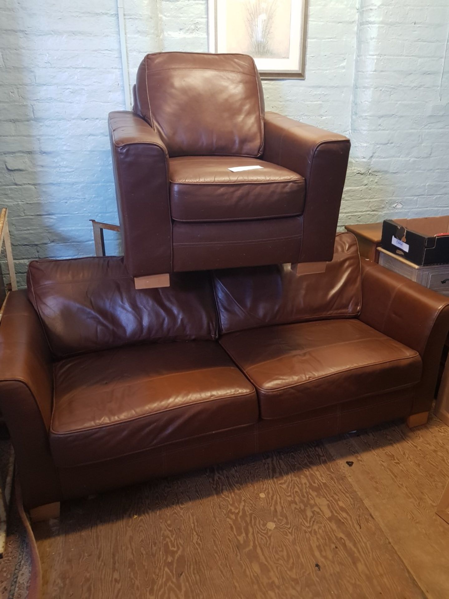 Contemporary mid brown leather 3 seater sofa and matching armchair.