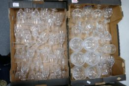 A large collection of quality cut glass crystal items including trifle dishes, wine glasses, port