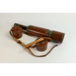 A Dollond of London brass and leather five drawer telescope with leather caps. 107cm long when