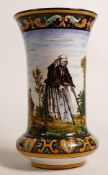 Early 20th century continental Faience vase decorated with old woman and man in church yard, h.21cm.