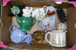 A collection of Wade including Novelty Teapots, Andy Cap Teapot, Toast Rack etc These were removed