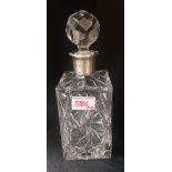 A crystal decanter with sterling silver collar