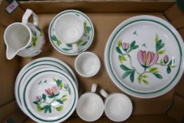 A collection of Portmerion Magnolia tea and dinner ware to include shallow bowls, cups, saucers,