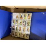 A collection of Cigarette Cards in multiple binders including themes of Pets, Wildlife, Royalty