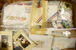 A mixed collection of items to include Stamps, First day covers, collectors cards, postcards etc